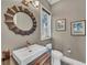 Chic powder room with a decorative mirror, stylish vanity, and elegant fixtures for a sophisticated touch at 416 Casey Key Rd, Nokomis, FL 34275