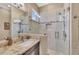 Bathroom with shower, glass wall, granite countertop, and modern fixtures at 416 Casey Key Rd, Nokomis, FL 34275