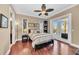 Bedroom with hardwood floors, ceiling fan, and a door leading to a balcony at 416 Casey Key Rd, Nokomis, FL 34275