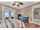Bedroom with hardwood floors, ceiling fan, and a door leading to a balcony at 416 Casey Key Rd, Nokomis, FL 34275