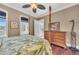 This bedroom has a unique canopy bed, with decor to match, and beautiful hardwood floors at 416 Casey Key Rd, Nokomis, FL 34275