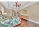 Relaxing bedroom with wood floors, tray ceilings, and tropical themed decor at 416 Casey Key Rd, Nokomis, FL 34275