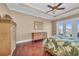 Comfortable bedroom featuring tray ceilings, wood floors, and sliding glass doors with water views at 416 Casey Key Rd, Nokomis, FL 34275