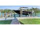 Waterfront property featuring a private boat dock with lift and lush landscaping at 416 Casey Key Rd, Nokomis, FL 34275