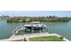 Dock area featuring boat lift with boat ready for the water and waterfront living at 416 Casey Key Rd, Nokomis, FL 34275