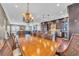Spacious dining room showcases a long table with wicker chairs and an ornate chandelier at 416 Casey Key Rd, Nokomis, FL 34275