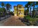Inviting home with dual garages, an impressive staircase, and a well-maintained brick driveway at 416 Casey Key Rd, Nokomis, FL 34275