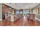 Open-concept kitchen boasts a large island, stainless steel appliances, and dark wood cabinetry at 416 Casey Key Rd, Nokomis, FL 34275