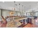 Modern kitchen boasts a large island with bar seating, stainless steel appliances, and ample counter space at 416 Casey Key Rd, Nokomis, FL 34275