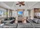 Cozy living room with a fireplace, built-in cabinets, plantation shutters and wood flooring at 416 Casey Key Rd, Nokomis, FL 34275