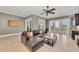 Open living room featuring a modern sectional sofa, neutral tile flooring, and a wet bar for easy entertaining at 416 Casey Key Rd, Nokomis, FL 34275