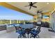 Covered outdoor kitchen featuring bar seating, dining area, and water view at 416 Casey Key Rd, Nokomis, FL 34275