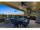 Covered outdoor kitchen featuring bar seating, dining area, and water view at 416 Casey Key Rd, Nokomis, FL 34275
