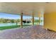 Covered patio with waterfront view features brick pavers and access to a private boat dock at 416 Casey Key Rd, Nokomis, FL 34275