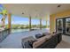 Expansive covered patio with comfortable seating and stunning waterfront views, perfect for outdoor relaxation and entertaining at 416 Casey Key Rd, Nokomis, FL 34275