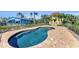 Backyard kidney-shaped pool featuring brick pool deck and lush landscaping at 416 Casey Key Rd, Nokomis, FL 34275