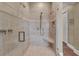 Modern tile shower with seat, dual shower heads, and glass door at 416 Casey Key Rd, Nokomis, FL 34275
