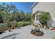 Exterior view of house surrounded by flower pots, plants, and trees in yard at 4326 Brackenwood Ct, Sarasota, FL 34232