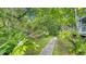 A cozy hammock is nestled among lush greenery, accessible by a charming wood path at 4326 Brackenwood Ct, Sarasota, FL 34232