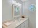 Bathroom features white vanity, drawers, crystal hardware, octagon window, and decorative lighting at 4326 Brackenwood Ct, Sarasota, FL 34232