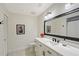 Elegant bathroom with white vanity, marble countertop, decorative mirror, and modern fixtures at 4326 Brackenwood Ct, Sarasota, FL 34232