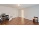 Spacious room featuring hardwood floors, neutral walls, and a modern lighting fixture at 4326 Brackenwood Ct, Sarasota, FL 34232