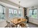 Sunny dining area featuring a wooden table, four chairs, and a wine rack at 4326 Brackenwood Ct, Sarasota, FL 34232
