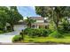 Charming two-story home featuring a manicured lawn, mature trees, and an attached two-car garage at 4326 Brackenwood Ct, Sarasota, FL 34232
