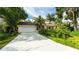 Charming home with attached garage, lush landscaping, and mature trees, creating a warm and inviting curb appeal at 4326 Brackenwood Ct, Sarasota, FL 34232