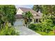 Beautiful home with a well-maintained lawn, mature trees and a driveway leading to an attached garage at 4326 Brackenwood Ct, Sarasota, FL 34232