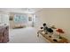 Bedroom with large windows, neutral carpet, sitting area, and antique-style decor at 4326 Brackenwood Ct, Sarasota, FL 34232