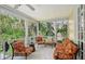 Relaxing screened-in porch with comfortable seating and views of lush greenery at 4326 Brackenwood Ct, Sarasota, FL 34232