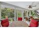 Inviting screened-in porch with comfortable seating and lush green scenery at 4326 Brackenwood Ct, Sarasota, FL 34232