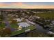 Aerial view of a waterfront property featuring a blue house, a boat lift, and a private canal at 4517 Pinfish Ln, Palmetto, FL 34221