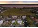 Aerial view of waterfront property with a boat dock and large land plot in the distance at 4517 Pinfish Ln, Palmetto, FL 34221