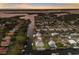 Stunning aerial view of waterfront homes with boat docks on a canal leading to the bay at sunset at 4517 Pinfish Ln, Palmetto, FL 34221