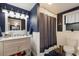 Bathroom features a white vanity, modern lighting, and a shower with curtain at 4517 Pinfish Ln, Palmetto, FL 34221