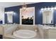 Elegant bathroom featuring a soaking tub, double vanities, stylish lighting, and a view at 4517 Pinfish Ln, Palmetto, FL 34221