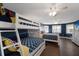 Spacious bedroom with a bunk bed, queen bed, and stylish decor at 4517 Pinfish Ln, Palmetto, FL 34221