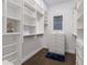 Organized walk-in closet with shelving, drawers, and ample storage space, illuminated by natural light at 4517 Pinfish Ln, Palmetto, FL 34221
