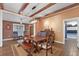 Inviting dining room with wooden beams, long table and a mix of bench and chair seating at 4517 Pinfish Ln, Palmetto, FL 34221