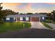 Charming single story home boasts of blue exterior, manicured lawn and attached two car garage at 4517 Pinfish Ln, Palmetto, FL 34221