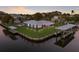 Waterfront home boasts a metal roof, lush landscaping, and a private dock with boat lift at 4517 Pinfish Ln, Palmetto, FL 34221