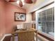 Cozy home office with a ceiling fan, natural light, desk and accent wall at 4517 Pinfish Ln, Palmetto, FL 34221
