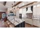 Elegant kitchen with white cabinetry, marble countertops, and a large central island with bar stool seating at 4517 Pinfish Ln, Palmetto, FL 34221