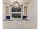 Bright butler's pantry features white cabinets, granite counters, and view of the canal at 4517 Pinfish Ln, Palmetto, FL 34221