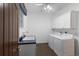 Bright laundry room with modern washer and dryer, sink, and ample storage space at 4517 Pinfish Ln, Palmetto, FL 34221