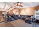 Open concept living room boasts beamed ceilings, wood-look floors, and a large leather sectional at 4517 Pinfish Ln, Palmetto, FL 34221