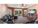 Comfortable living room features a large sectional sofa, hardwood floors, and a view of the backyard at 4517 Pinfish Ln, Palmetto, FL 34221