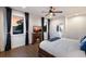 Comfortable main bedroom with fireplace, TV, and sunset views from the windows, overlooking the canal at 4517 Pinfish Ln, Palmetto, FL 34221